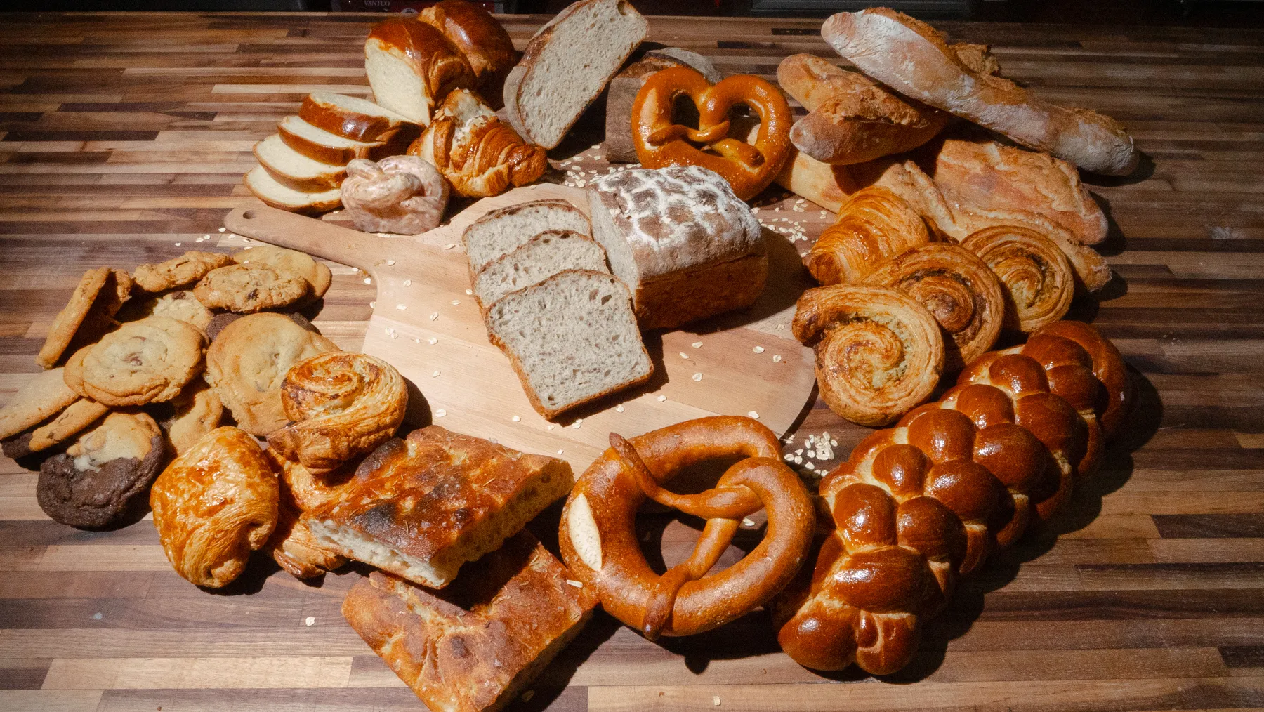 Freshly baked sourdough loaves cooling on a wooden rack